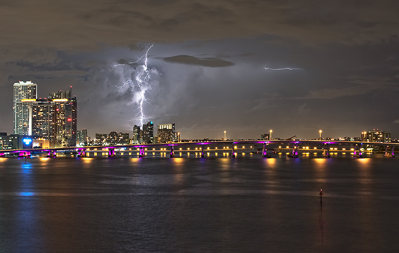 Lightning above the Miami skyline and its reflection in the water.