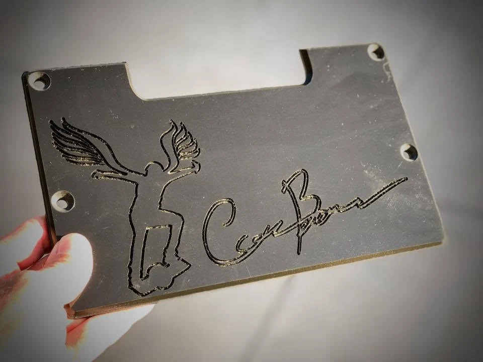 An engraved metal grind plate with Cory’s winged rider artwork and signature.