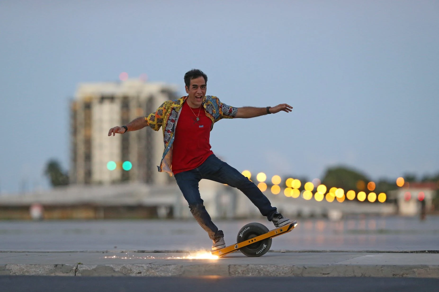 Chris Richardson jumping his Onewheel as Draggin Tail throws sparks over the pavement.