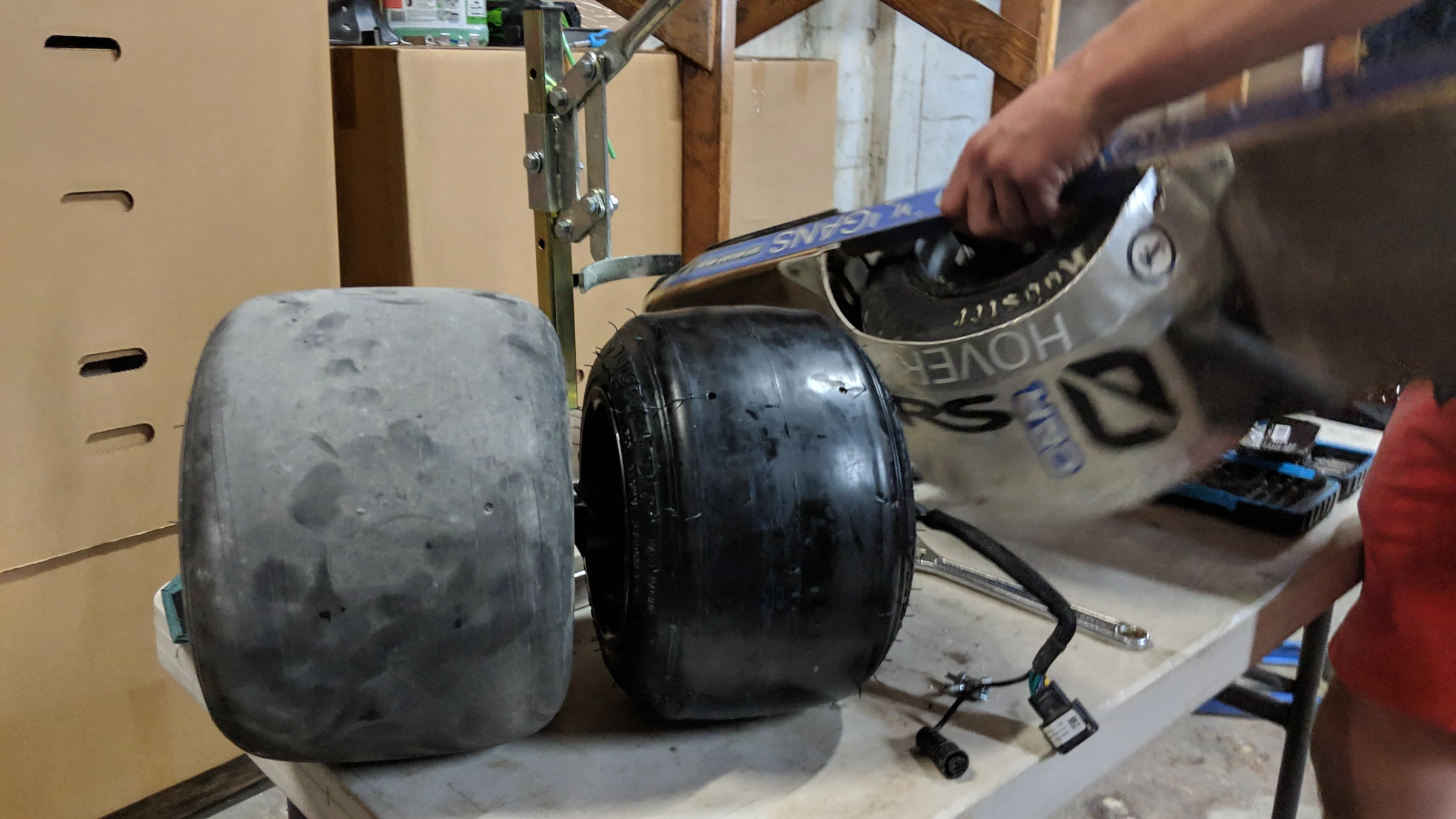 Removed Onewheel tires and board parts spread across a workbench.